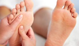 Close-up of female hands pampering feet