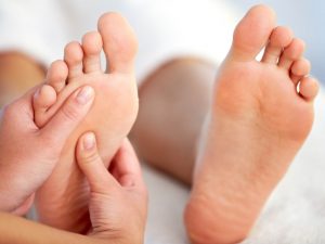 Close-up of female hands pampering feet